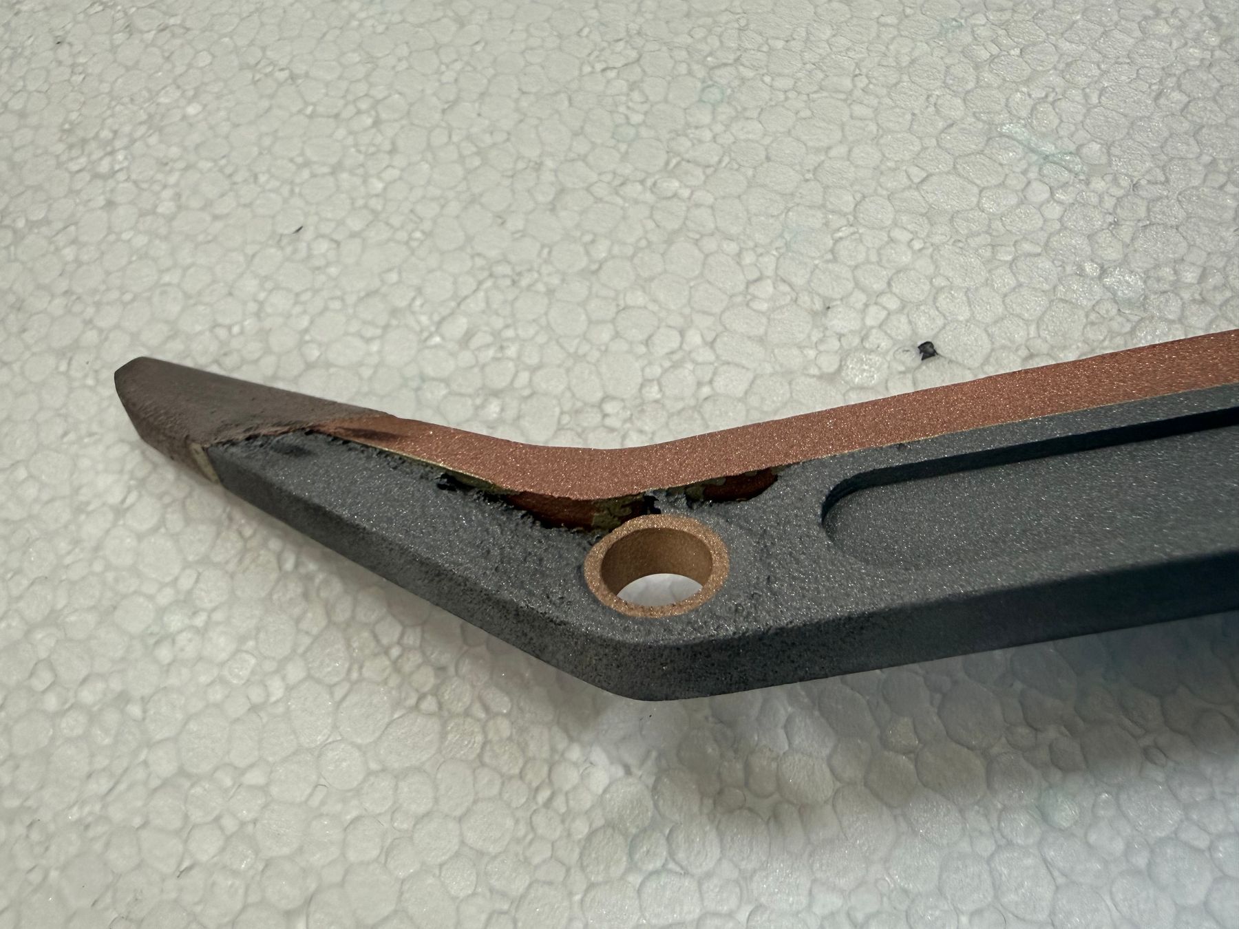 Transfer arm mounted on custom jig inside cold spray booth