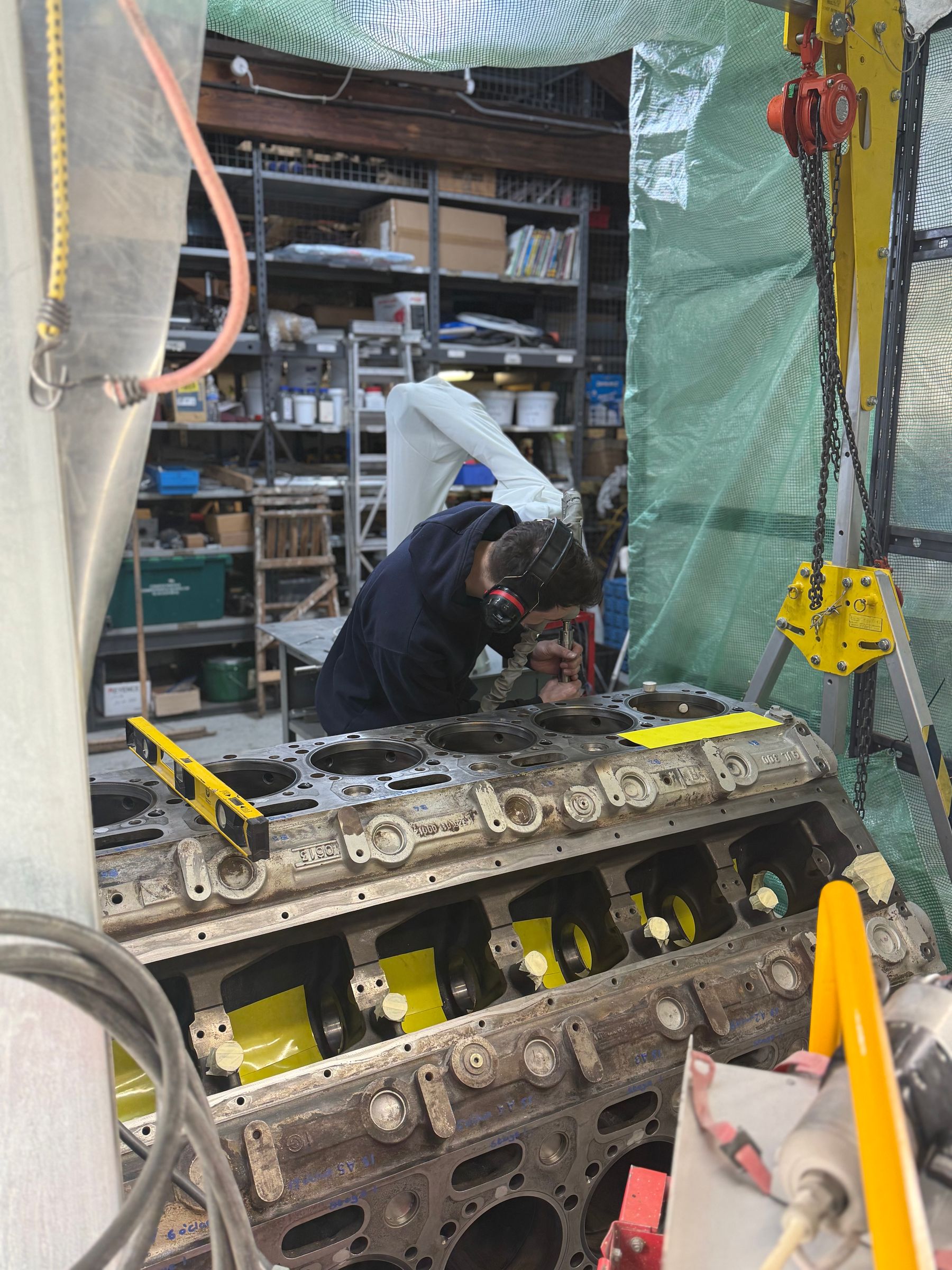 Close-up of technician inspecting V12 engine block liner bore housings